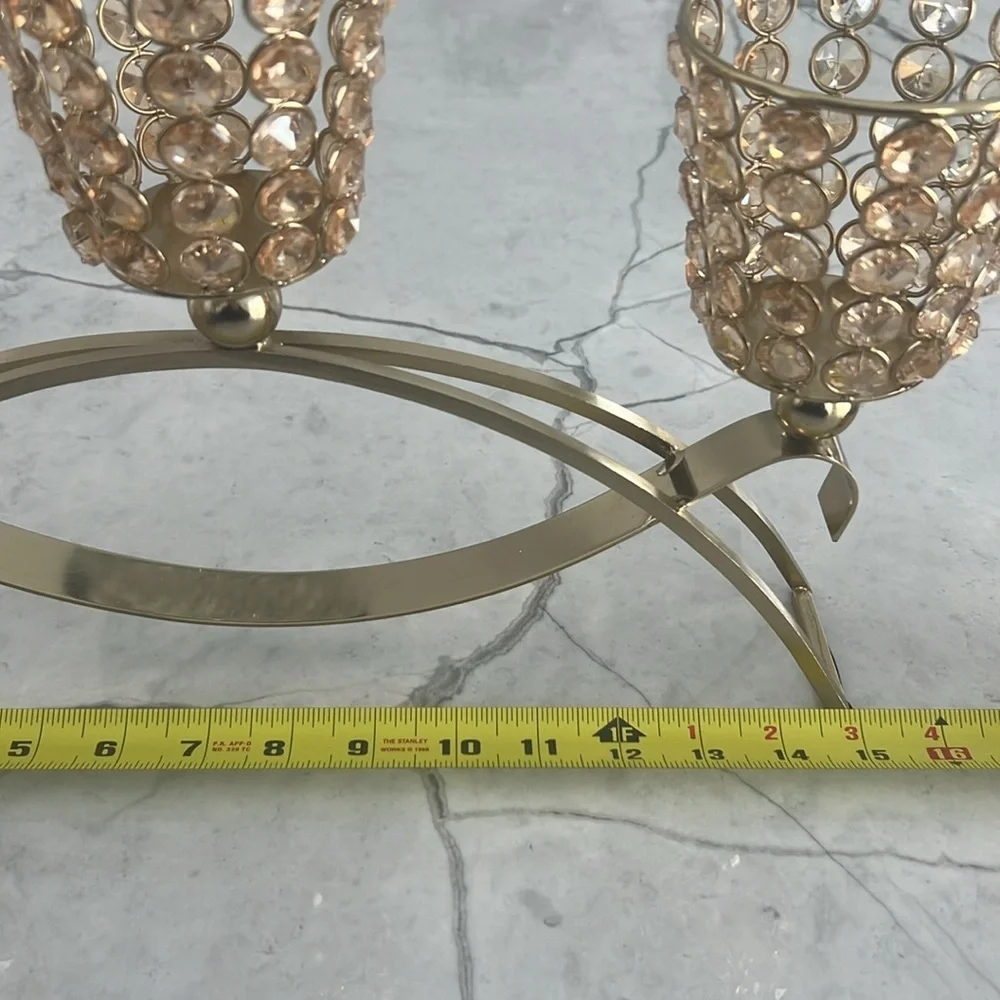 Elegant gold metal like candle holder with beautiful shiny crystal like gems